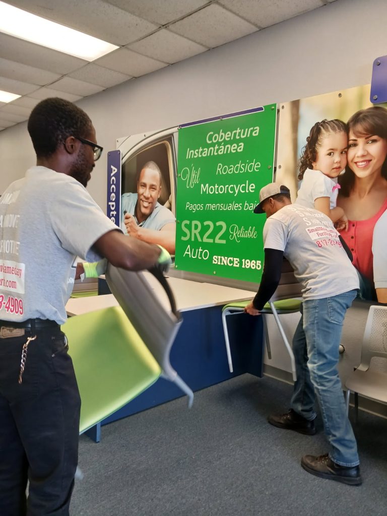 Professional commercial office movers in Fort Worth carefully relocating office furniture and chairs for a local business.