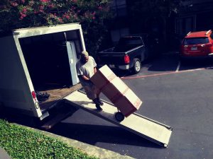 Same-day furniture delivery movers in Fort Worth using a truck ramp to load residential items